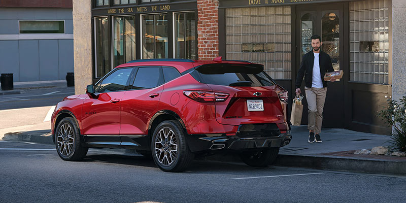 A red Chevrolet SUV parked with a person walking away.
